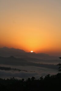 Peaceful golden sunrise over misty mountain valley, symbolizing hope and blessing