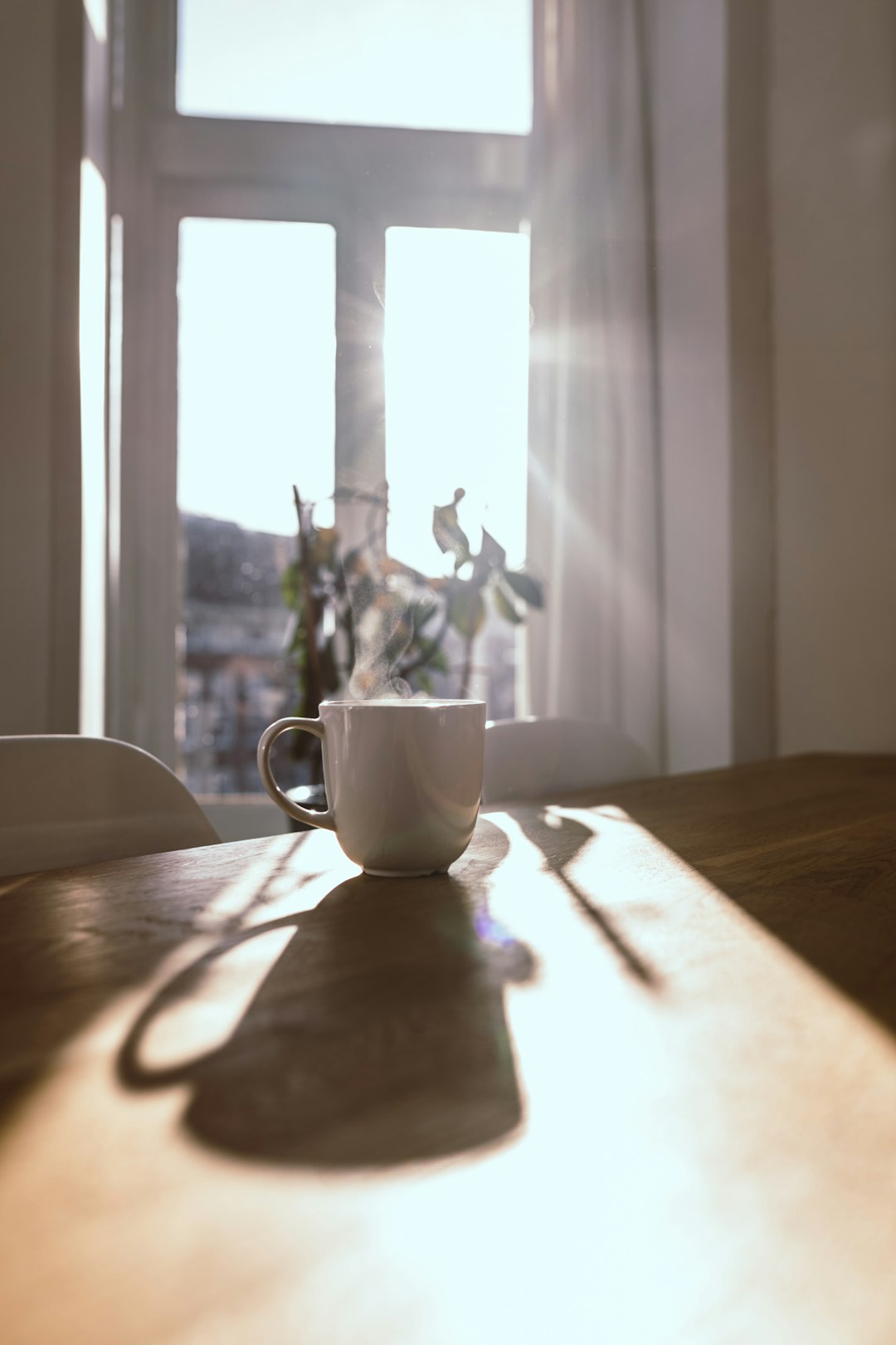 Steaming coffee mug by a sunlit window for a good morning blessing