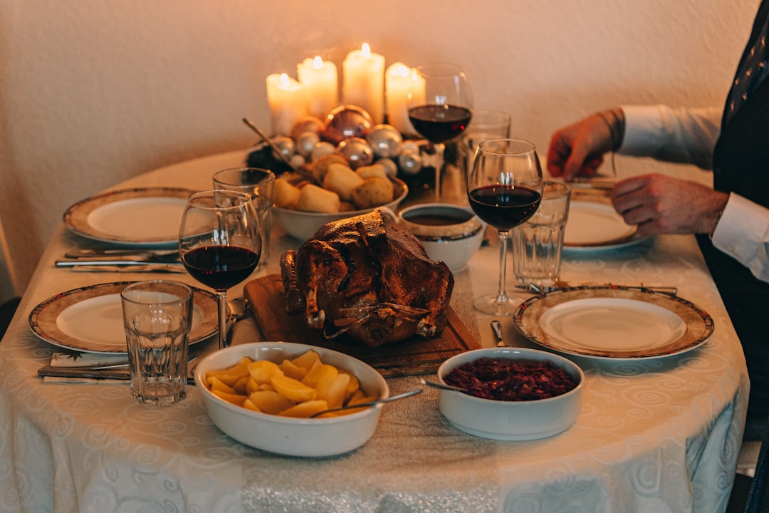 Thanksgiving dinner table spread with turkey and dishes for family gratitude prayer