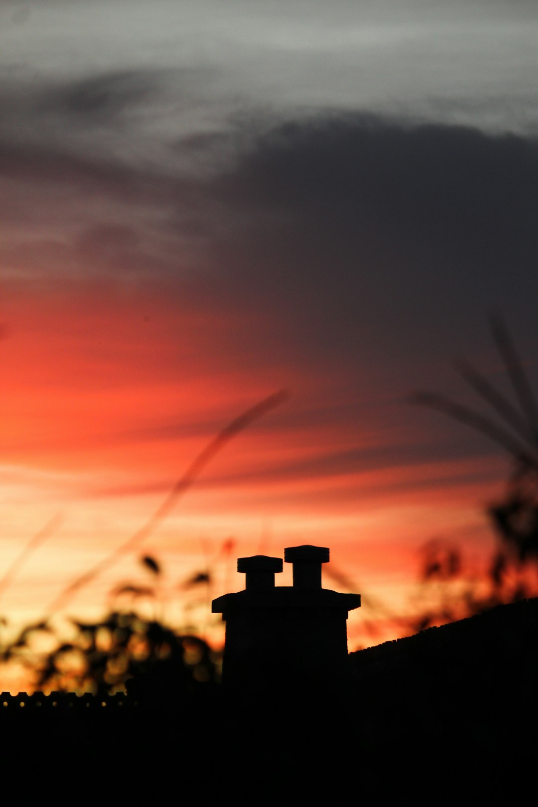 Vibrant sunset sky with chimney silhouette for a good evening blessing